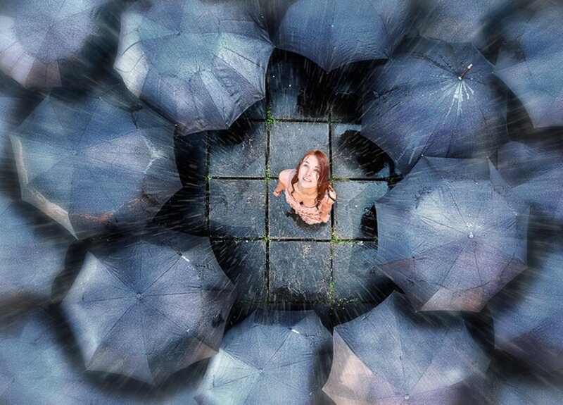 Woman in Rain with Umbrellas