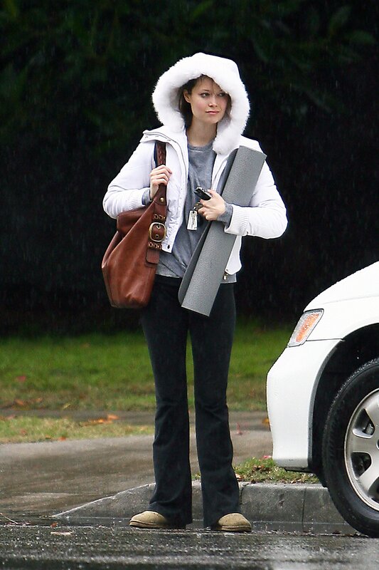 woman in rain with yoga mat