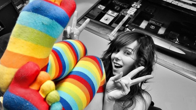 woman in rainbow socks making peace signs