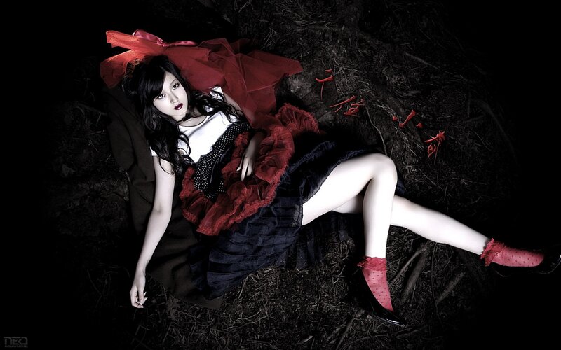 woman in red and black dress lying on ground