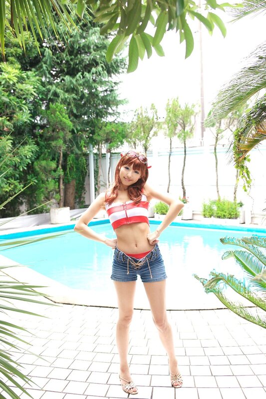 Woman in red and white bikini by pool