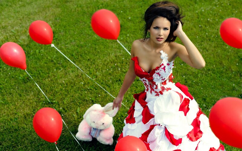 Woman in red and white dress with balloons