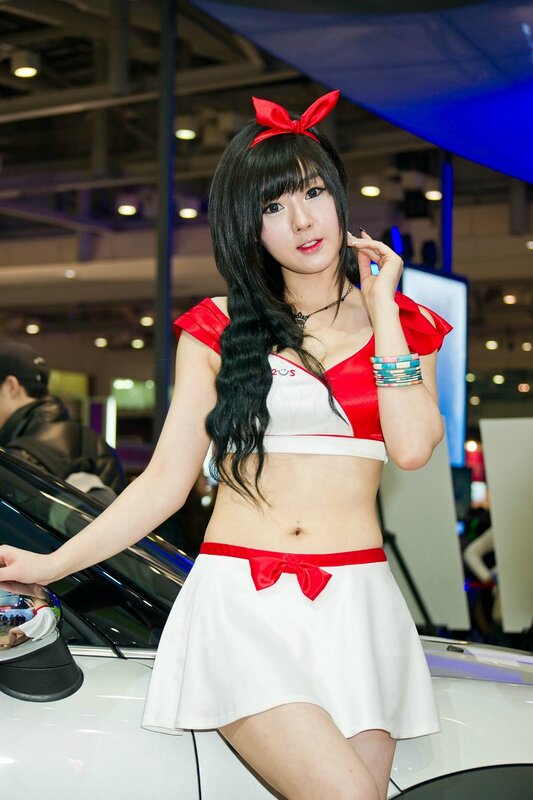 Woman in red and white outfit at car show