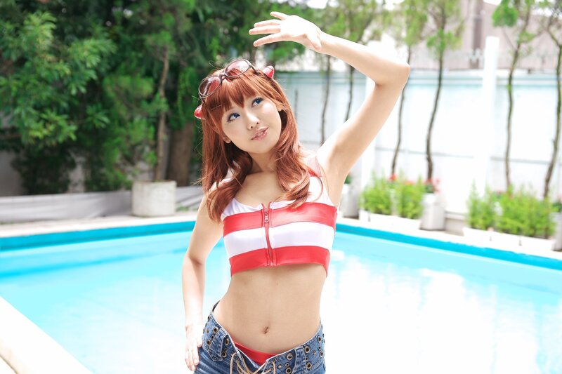 Woman in red and white top by pool