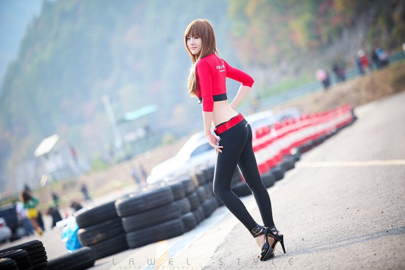 Woman in red at a racetrack