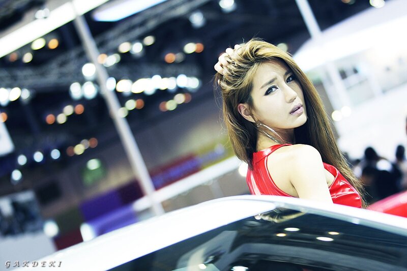 Woman in red at auto show