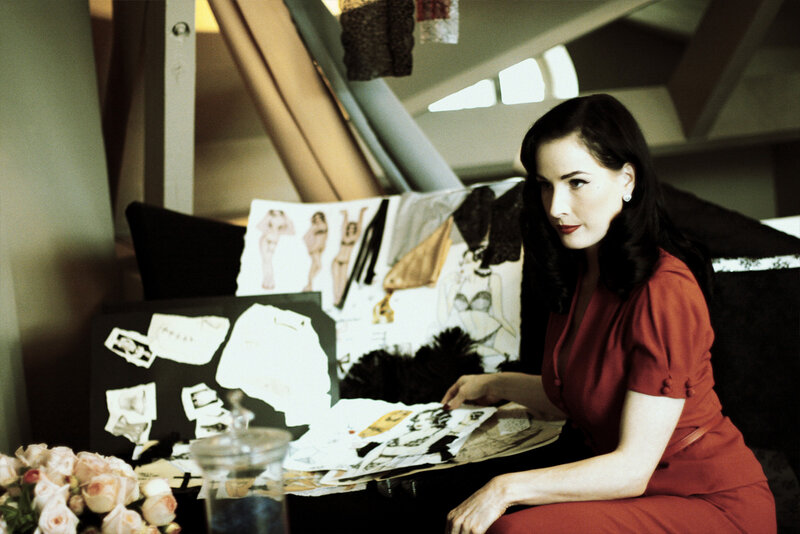 woman in red at design table