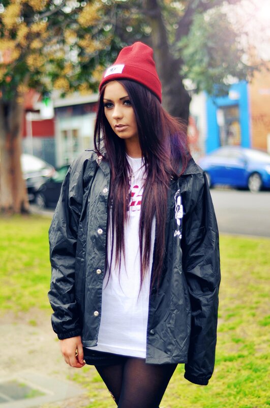 woman in red beanie and black jacket