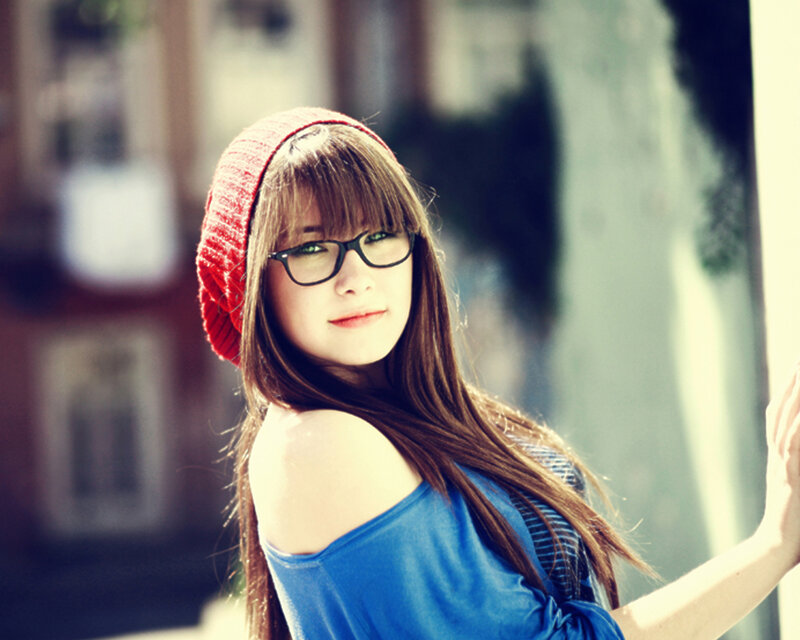 woman in red beanie and glasses