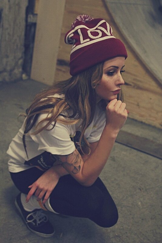 woman in red beanie crouching
