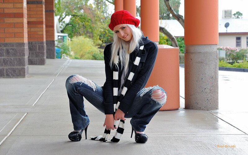 Woman in red beanie crouching