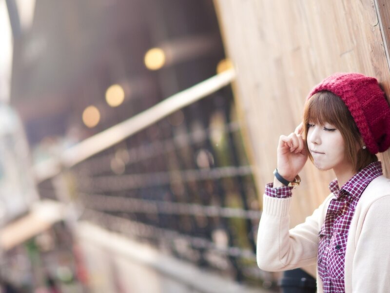 woman in red beanie leaning