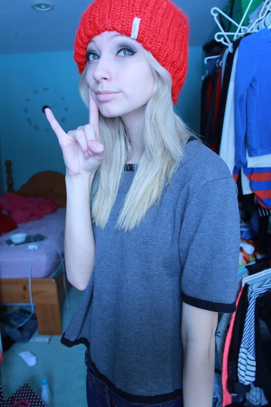 woman in red beanie making a gesture