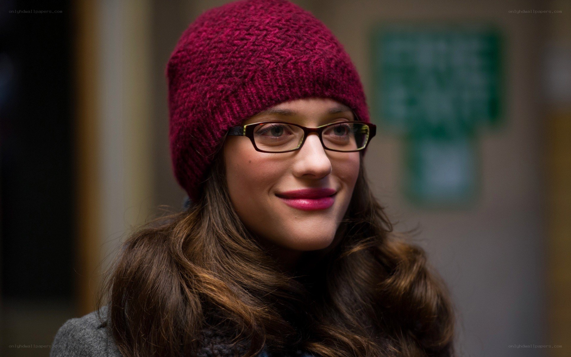 woman in red beanie smiling