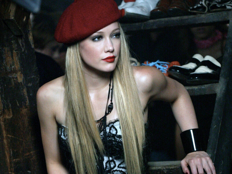 Woman in red beret and black dress