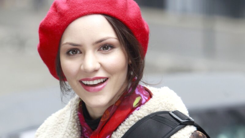 woman in red beret smiling