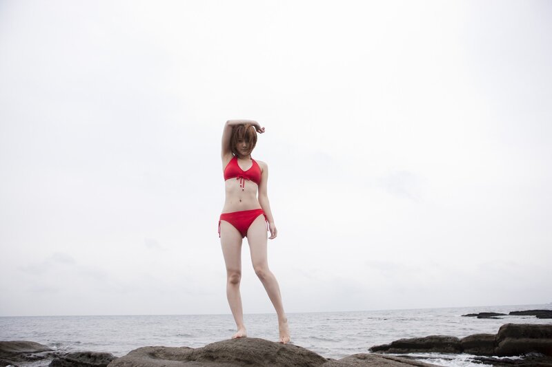 Woman in red bikini on rocks