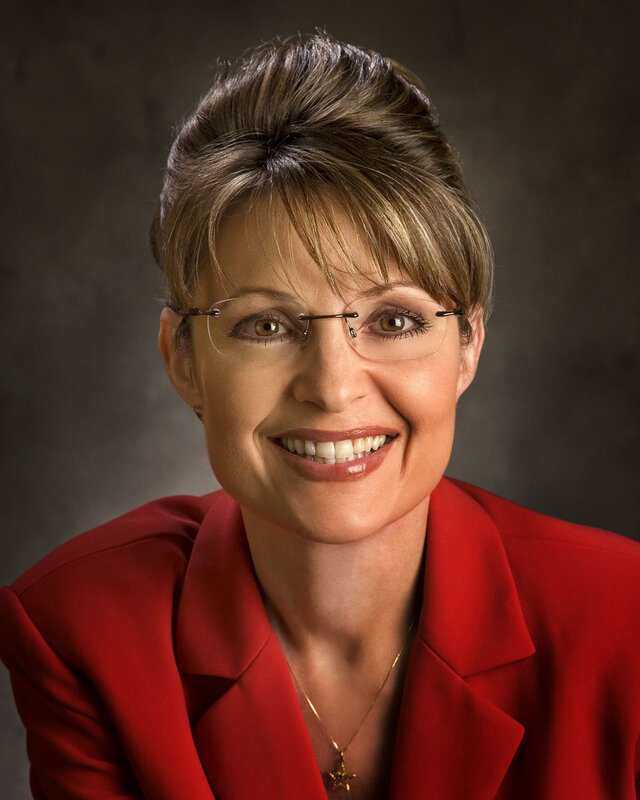 woman in red blazer smiling