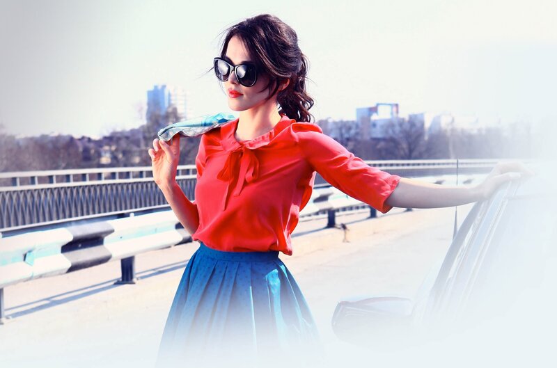 woman in red blouse on bridge
