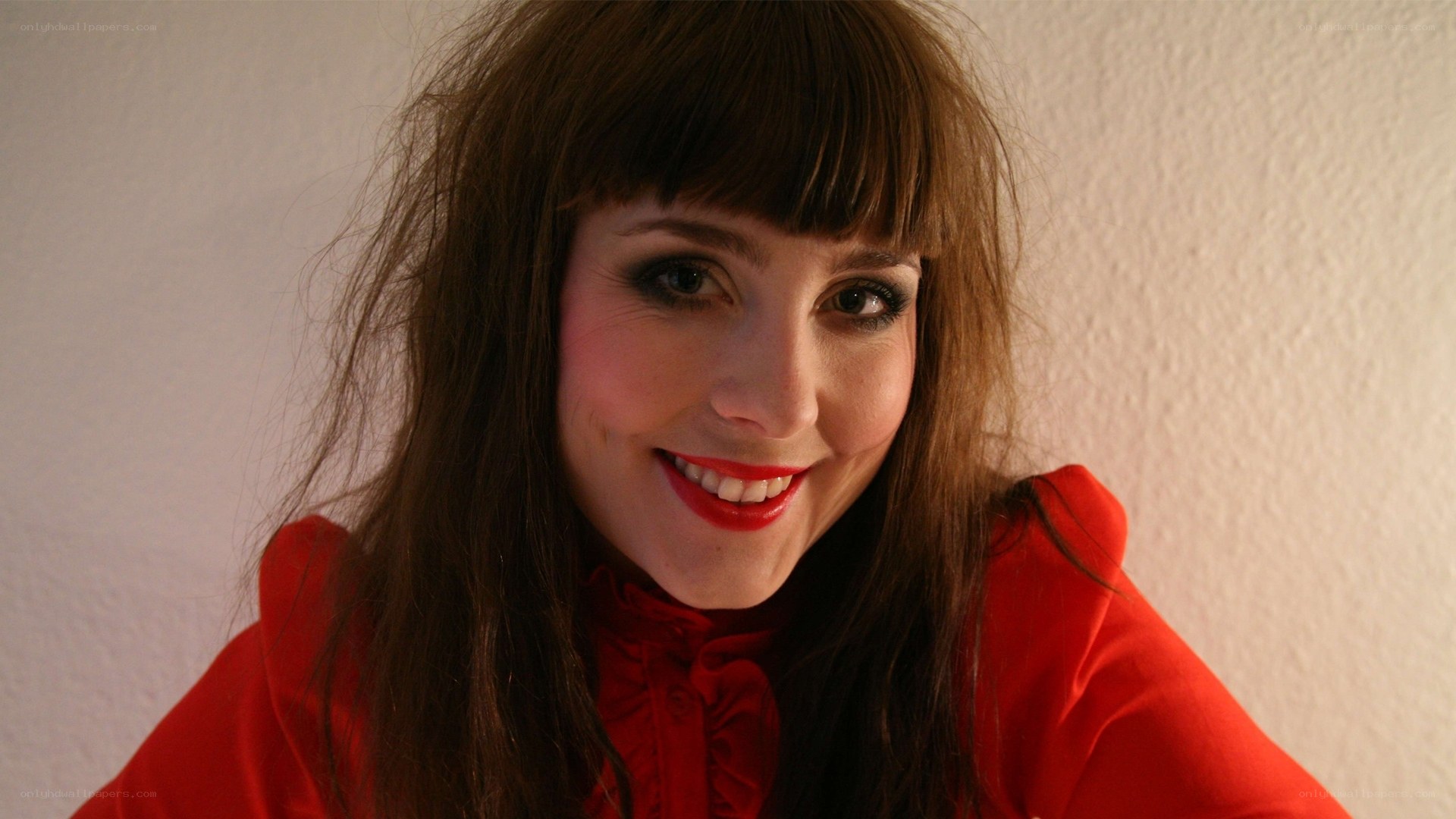 woman in red blouse smiling