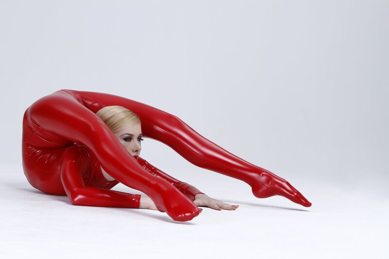 Woman in red bodysuit performing contortion