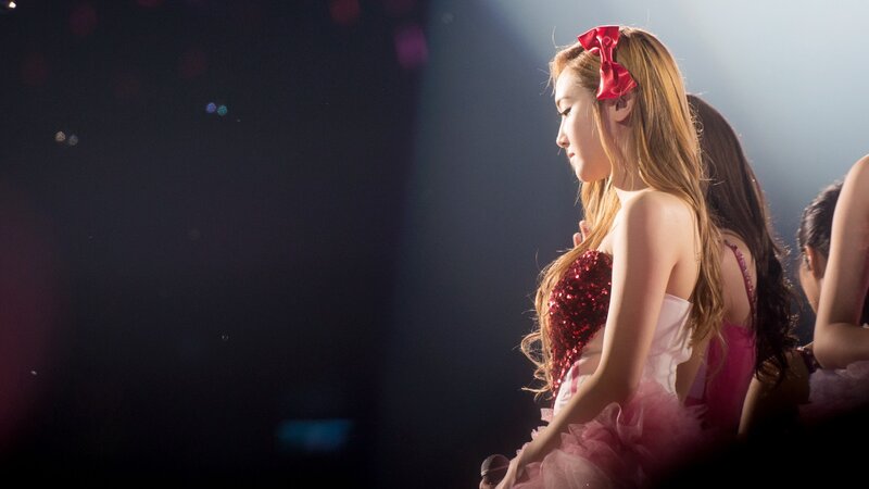 woman in red bow on stage
