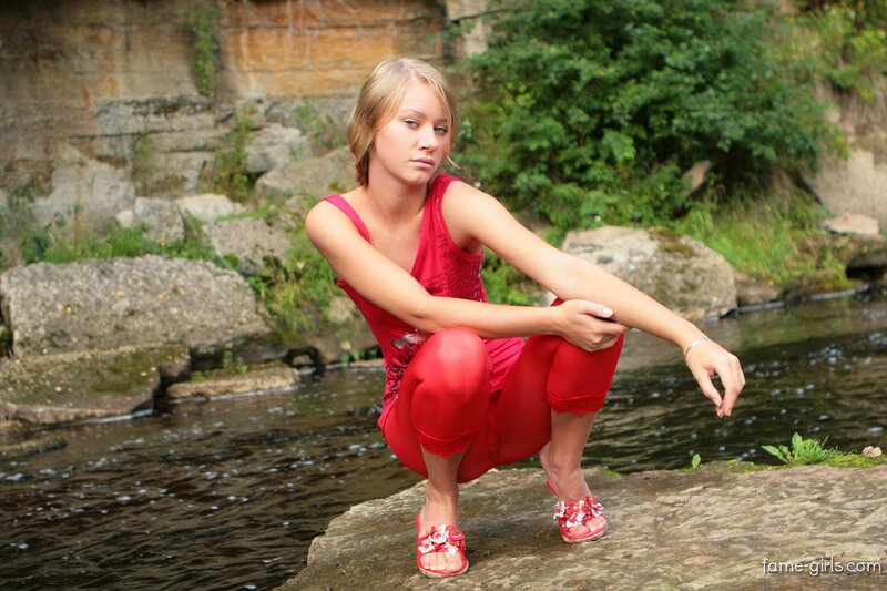 woman in red by a stream