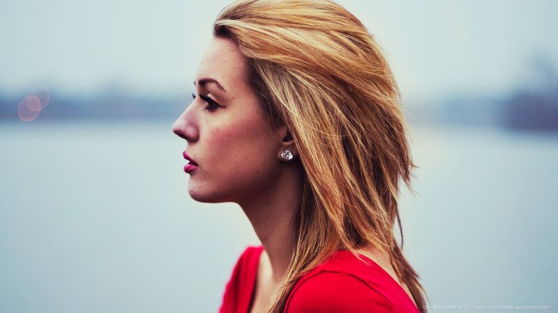 woman in red by water