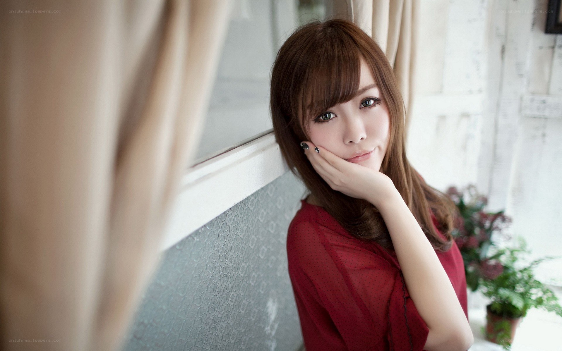 woman in red by window
