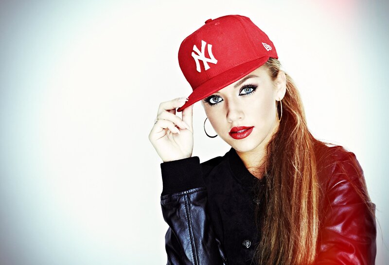 woman in red cap and leather jacket