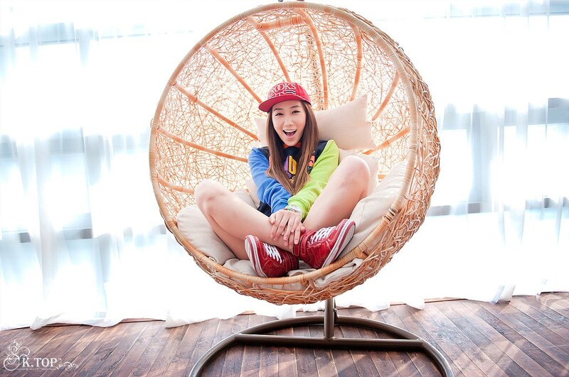 Woman in red cap sitting in chair