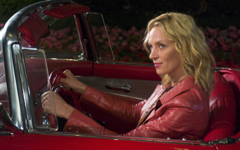 Woman in red car at night