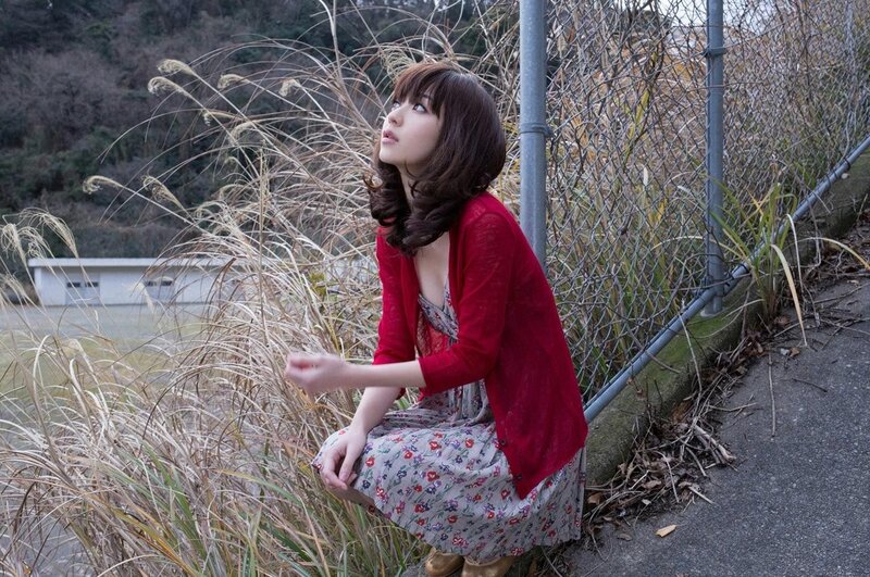 Woman in red cardigan crouching