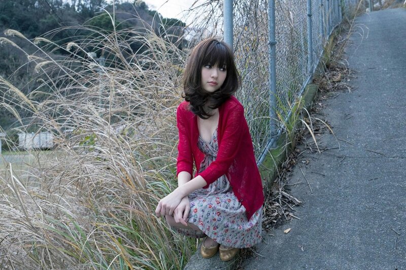 Woman in red cardigan crouching
