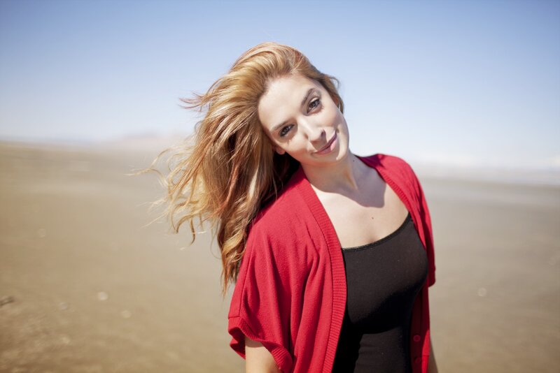 woman in red cardigan on beach