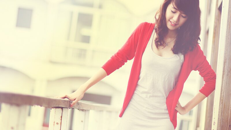 woman in red cardigan smiling