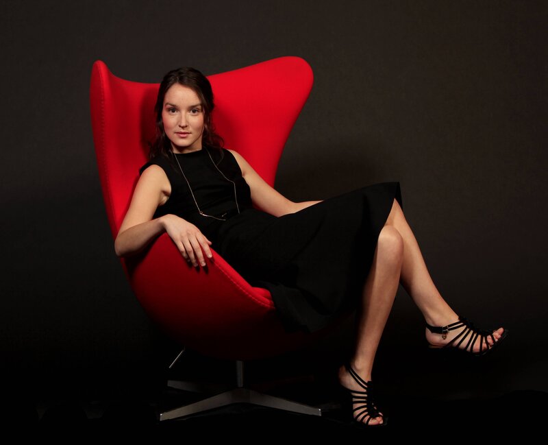 Woman in Red Chair — Dramatic, Photograph