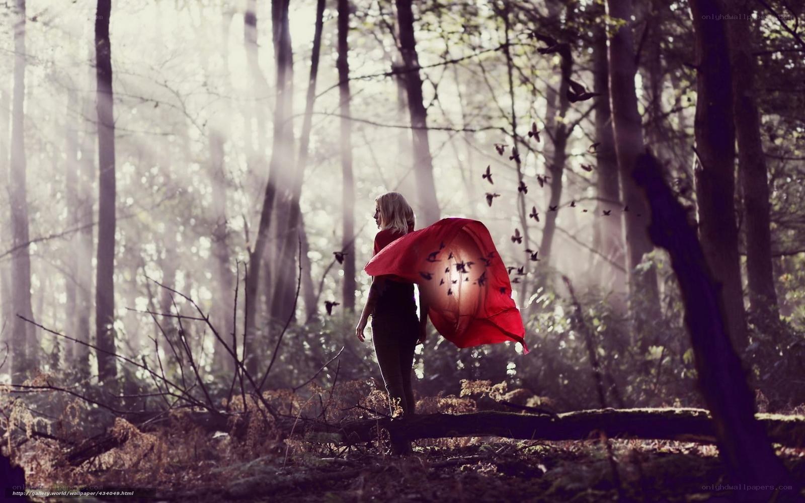 Woman in red cloak in forest