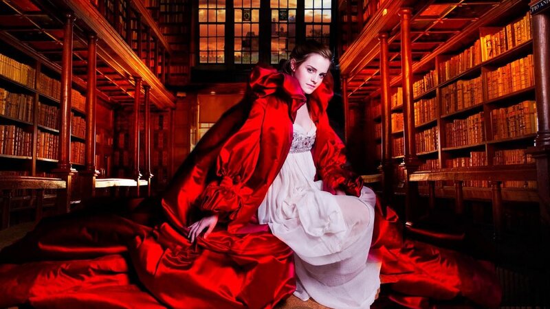 woman in red cloak in library