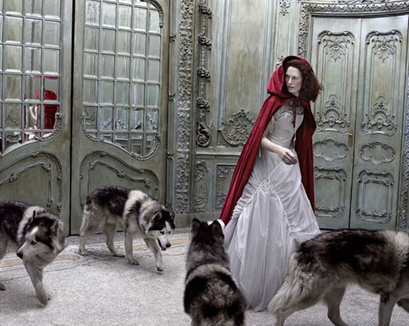 Woman in Red Cloak with Huskies — Dramatic