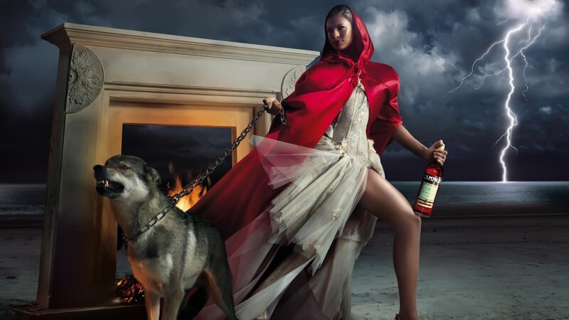 Woman in red cloak with wolf