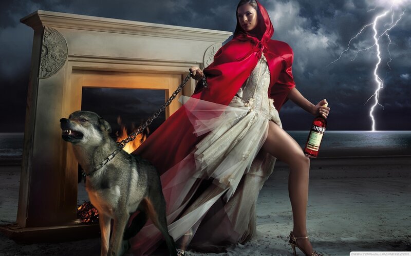 Woman in red cloak with wolf