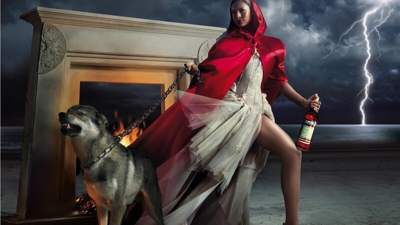 Woman in red cloak with wolf