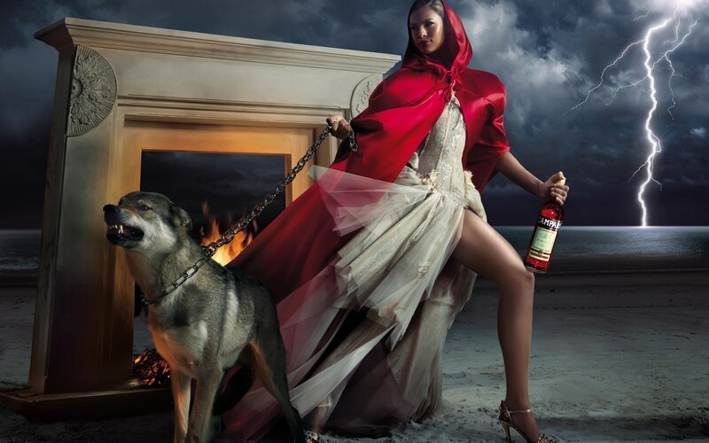 Woman in red cloak with wolf