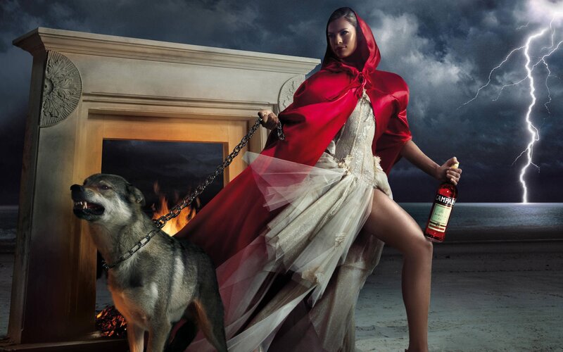 Woman in red cloak with wolf