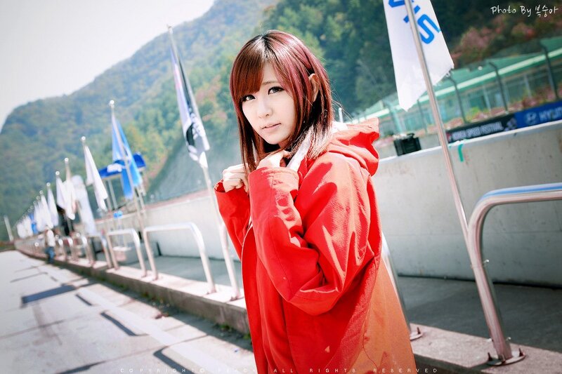 Woman in red coat at race track
