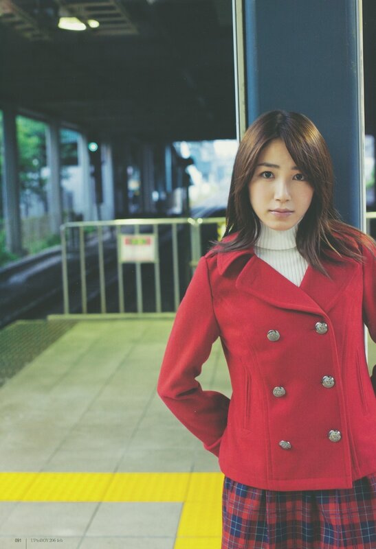 woman in red coat at train station