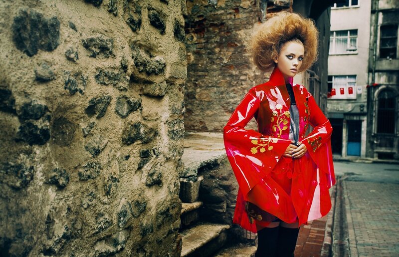 Woman in Red Coat — Dramatic, Photograph, Stone Wall