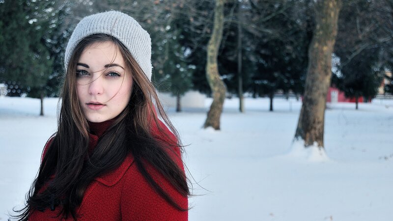woman in red coat in snow