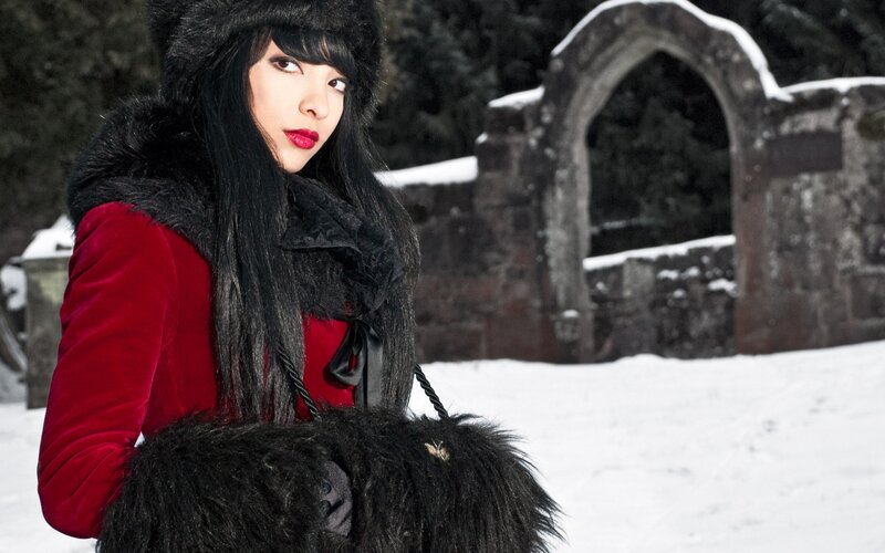 woman in red coat in snow